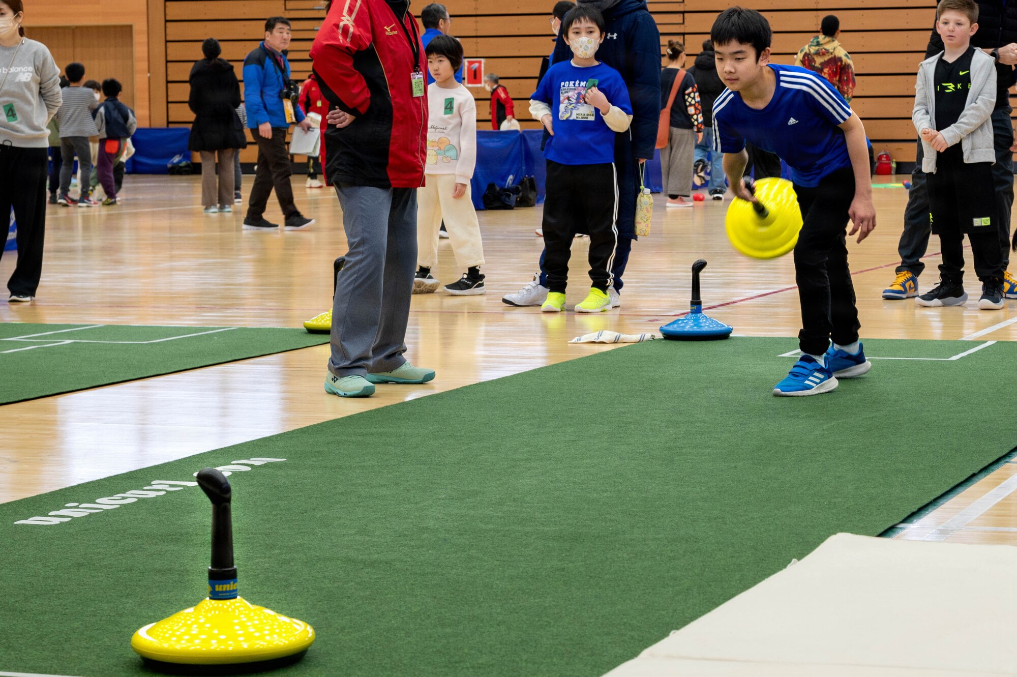 A participant aims toward the target during a unicurl game at the Misawa International Sports Center in Misawa City, Japan, Mar. 7, 2026.