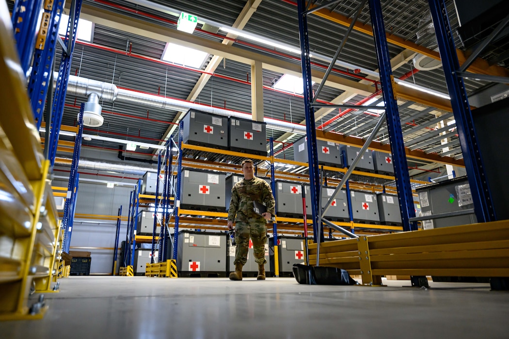 A person walks through a warehouse.