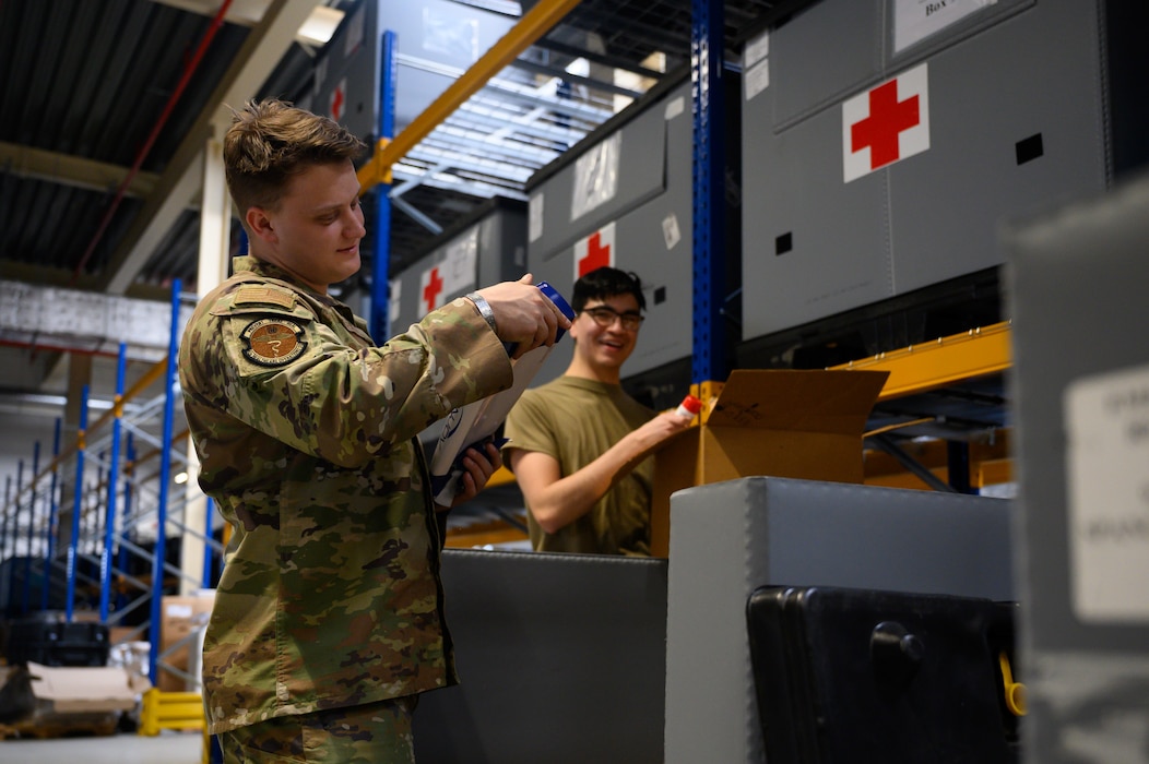 A person inspects medical supplies inside a warehouse.