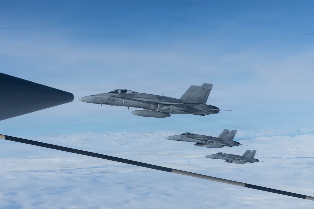 Finnish air force F/A-18 Hornets fly beside a KC-130J Super Hercules aircraft with Marine Aerial Refueler Transport Squadron (VMGR) 252, Marine Aircraft Group 14, 2nd Marine Aircraft Wing, near Evenes Air Station, Norway, March 16, 2026. VMGR-252 and the Finnish air force conducted air-to-air refueling operations during exercise Cold Response 26. A key component of NATO's enhanced vigilance activity Arctic Sentry, exercise Cold Response 26 is a Norwegian-led winter military exercise designed to enhance collective defense capabilities and ensure U.S. readiness to rapidly deploy and seamlessly operate alongside NATO Allies in challenging arctic conditions. (U.S. Marine Corps photo by Cpl. Mya Seymour)