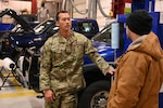 U.S. Air National Guard Master Sgt. Anthony Lesle, 168th Logistics Readiness Squadron, 168th Transportation Flight, discusses vehicle maintenance statuses at the 168th Wing, ensuring fleet readiness in support of operations and winter conditions. Photo by Senior Master Sgt. Julie Avey.