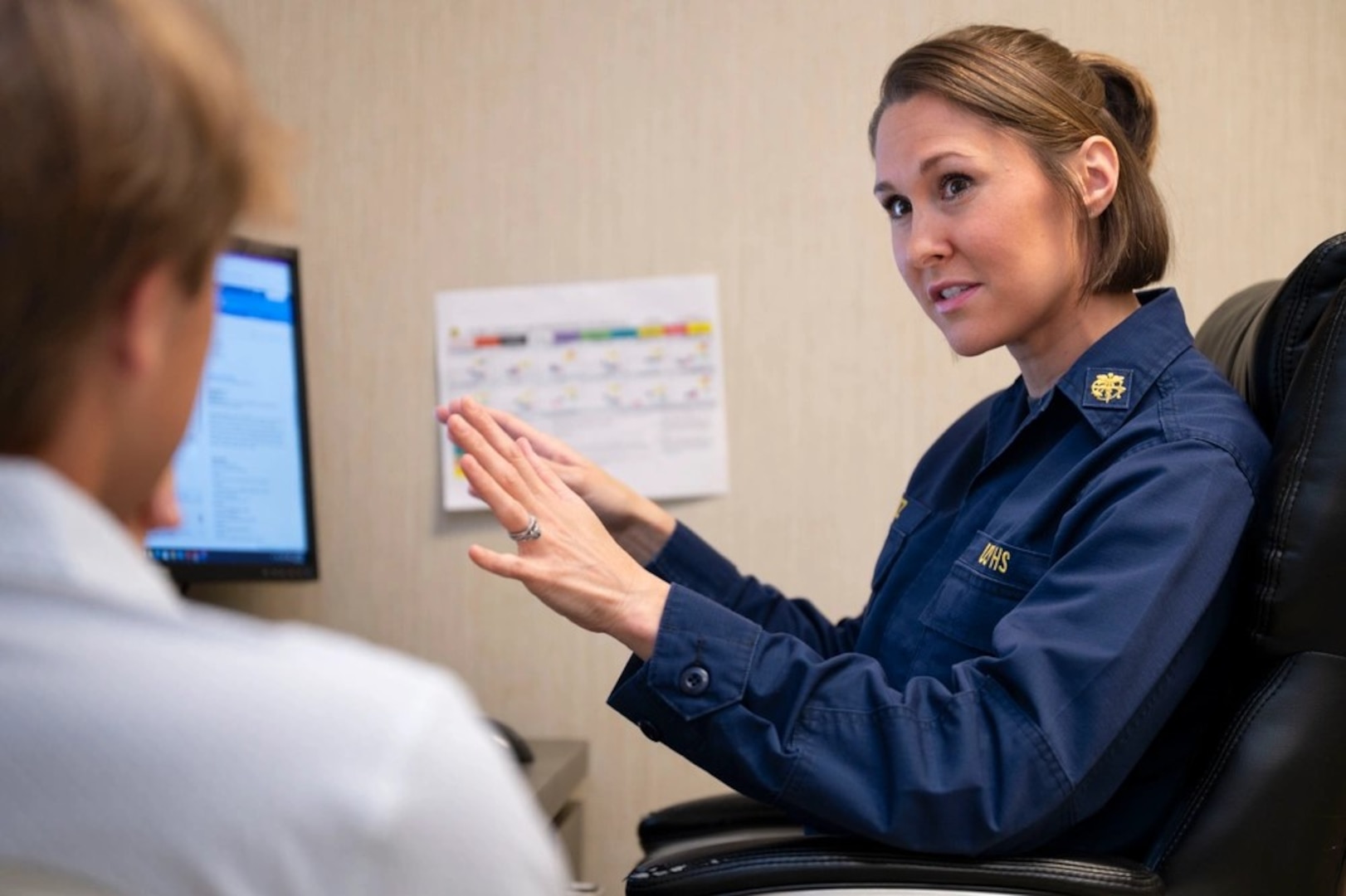 Lt. Amber Martz, a nurse practitioner with the USPHS Commissioned Corps, consults with an applicant after a physical at Memphis MEPS. Martz serves as the first-ever USPHS officer within USMEPCOM.