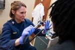 Lt. Amber Martz, a nurse practitioner with the USPHS Commissioned Corps, conducts a physical with an applicant at Memphis MEPS. Martz serves as the first-ever USPHS officer within USMEPCOM.
