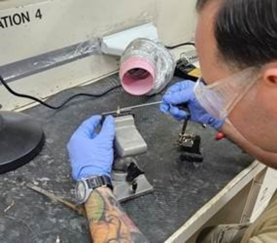 Technical Sgt. Jarid McCray, 435th Intelligence Squadron, prepares to solder a turret terminal during a basic soldering techniques course
