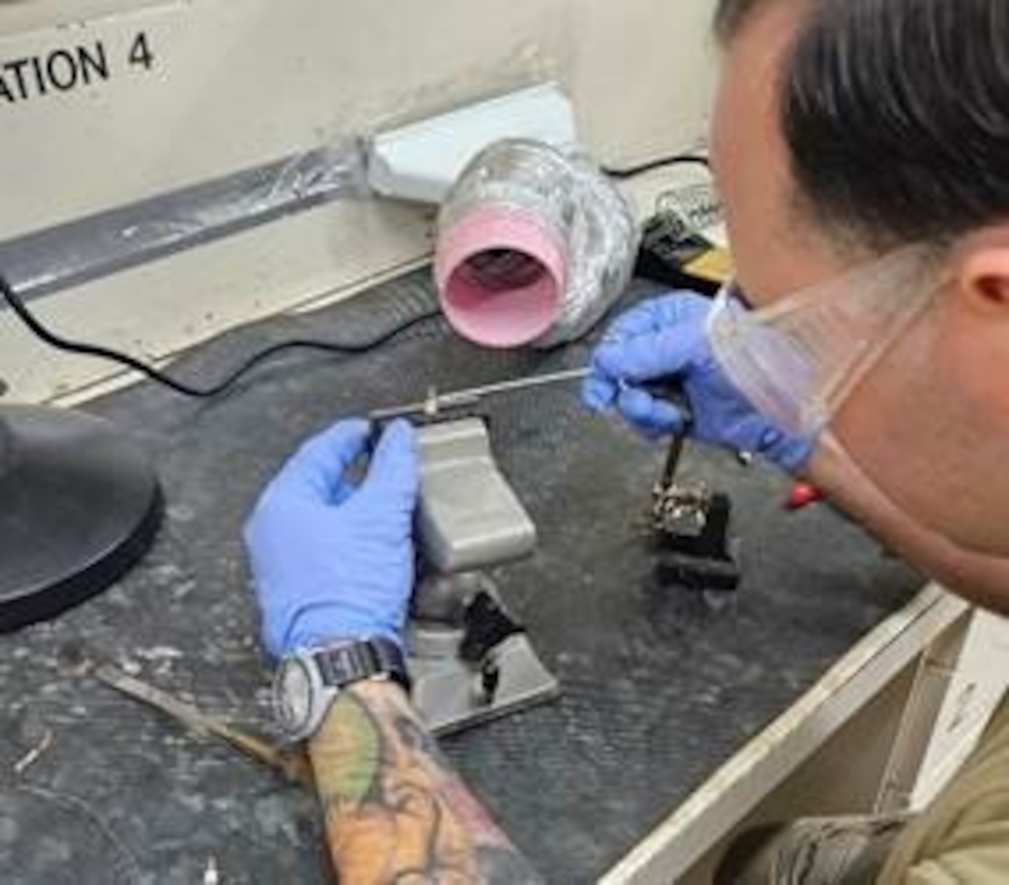 Technical Sgt. Jarid McCray, 435th Intelligence Squadron, prepares to solder a turret terminal during a basic soldering techniques course