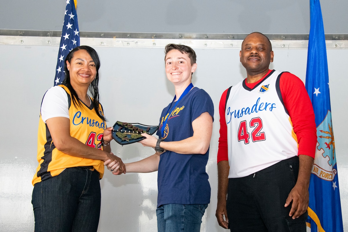 U.S. Air Force Col. Shamekia Toliver, commander of the 42nd Air Base Wing, and Chief Master Sgt. Demetrius N. Booth, command chief of the 42nd ABW, present an award to Senior Airman Lauren Dearborff  for Airman of the Year during the 42nd ABW Annual Award Ceremony at Maxwell Air Force Base, Alabama, March. 6, 2026. Leadership recognized the hard work and dedication of each award recipient in support of the mission. (U.S. Air Force photo by Darius Hutton)