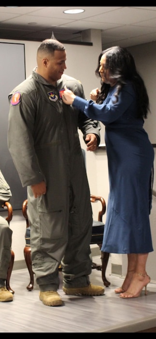U.S. Air Force Master Sgt. Kristopher Mack, is presented his next rank of Senior Master Sgt. by his wife, Cristina, October 2024 at Altus Air Force Base, Okla. Mack says his wife has been instrumental to his career. (Courtesy photo)