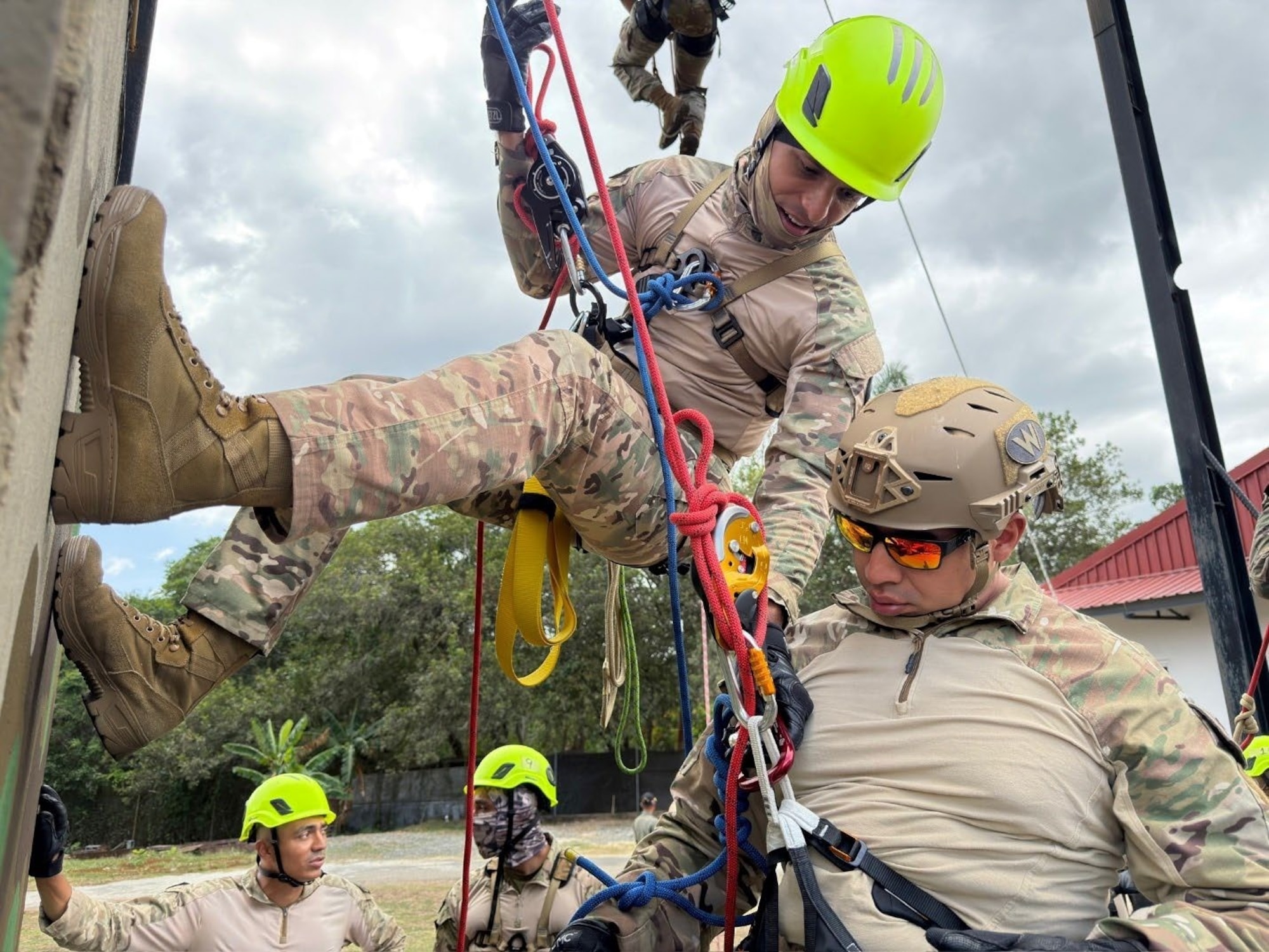 Men practice repelling on ropes.