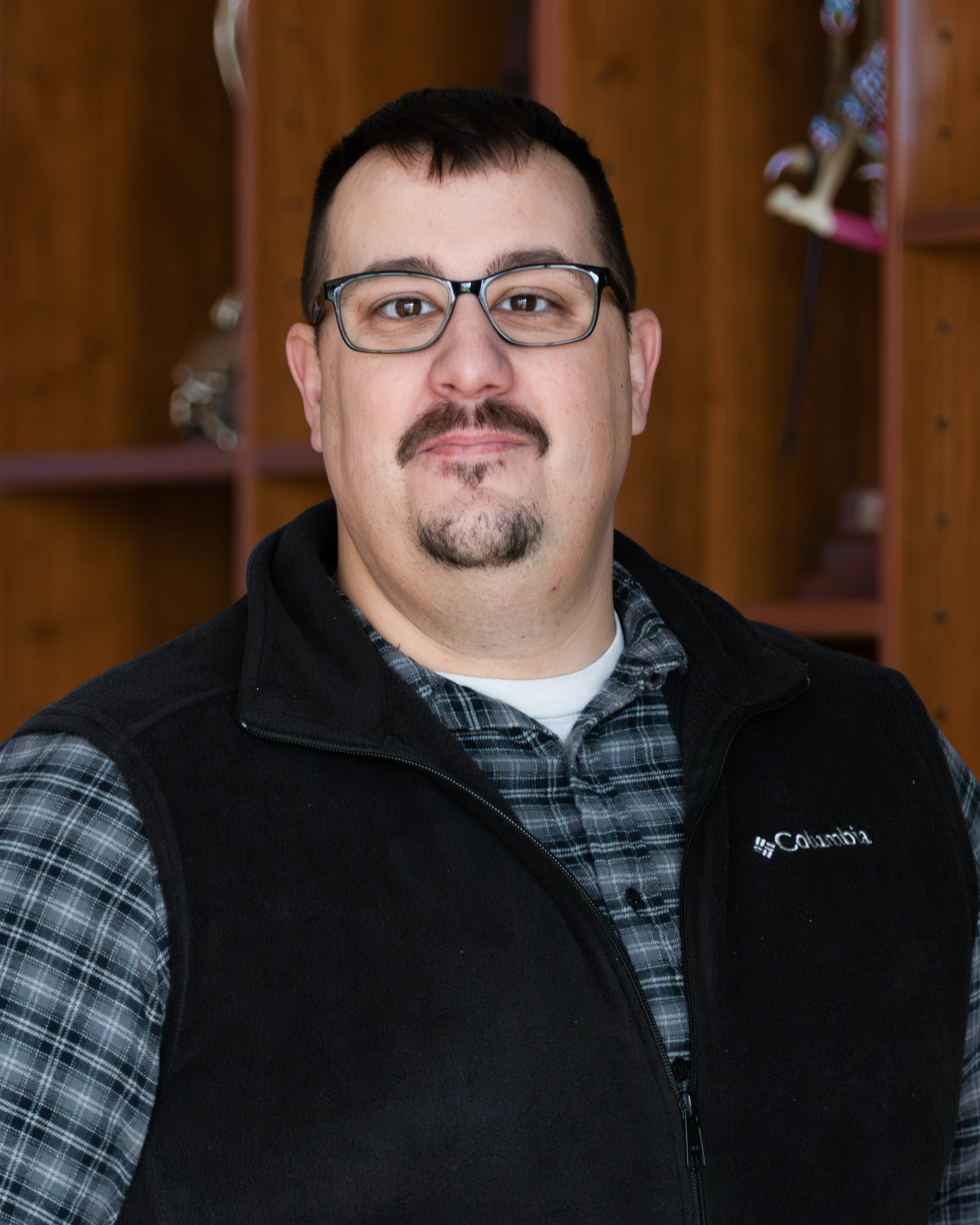 Headshot of Christopher Baker, Administrative and Finance Officer, against a neutral background.