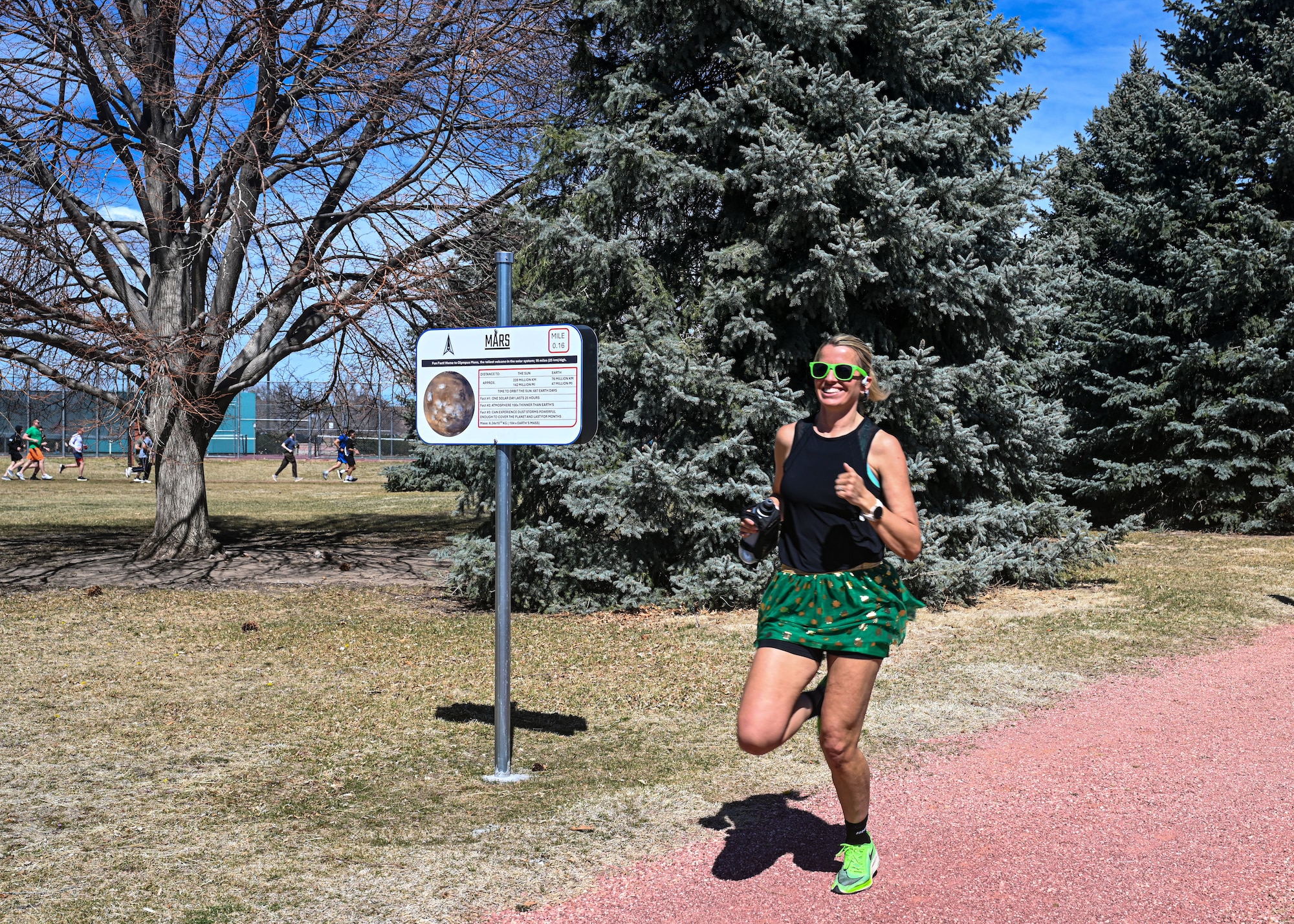 A runner passes by a sign.