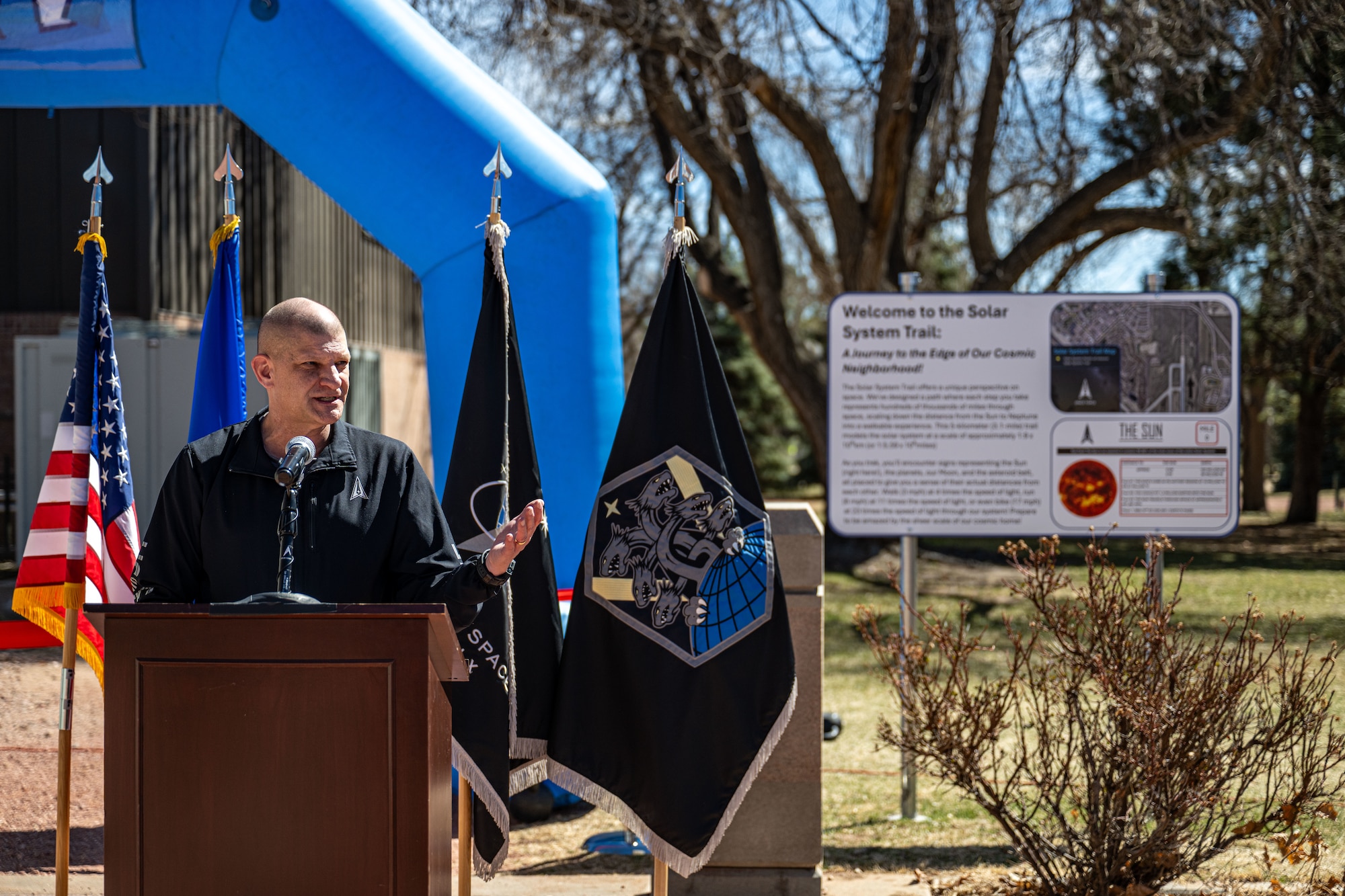 A service member speaks to an audience.