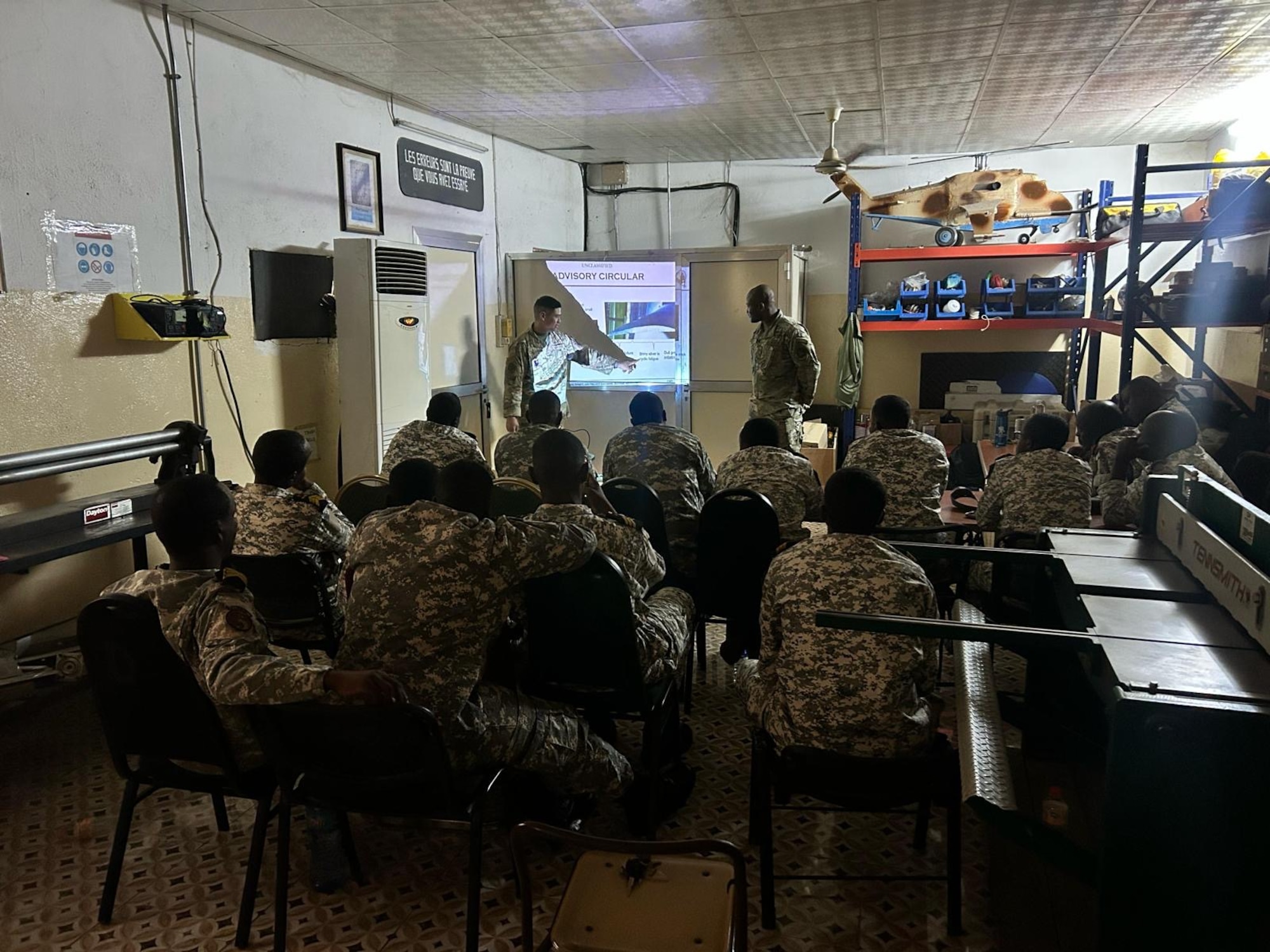 Men learn in a classroom.