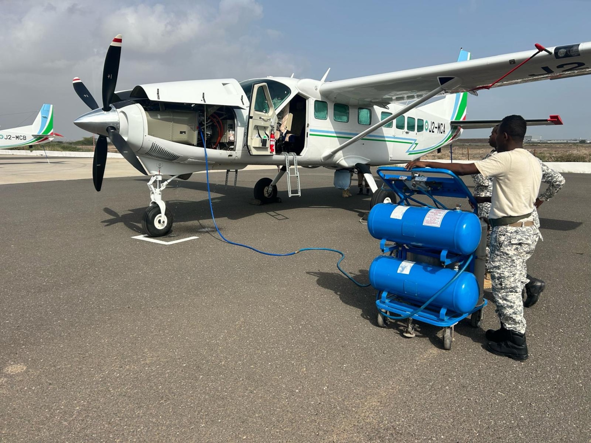 men perform maintenance on an aircraft.