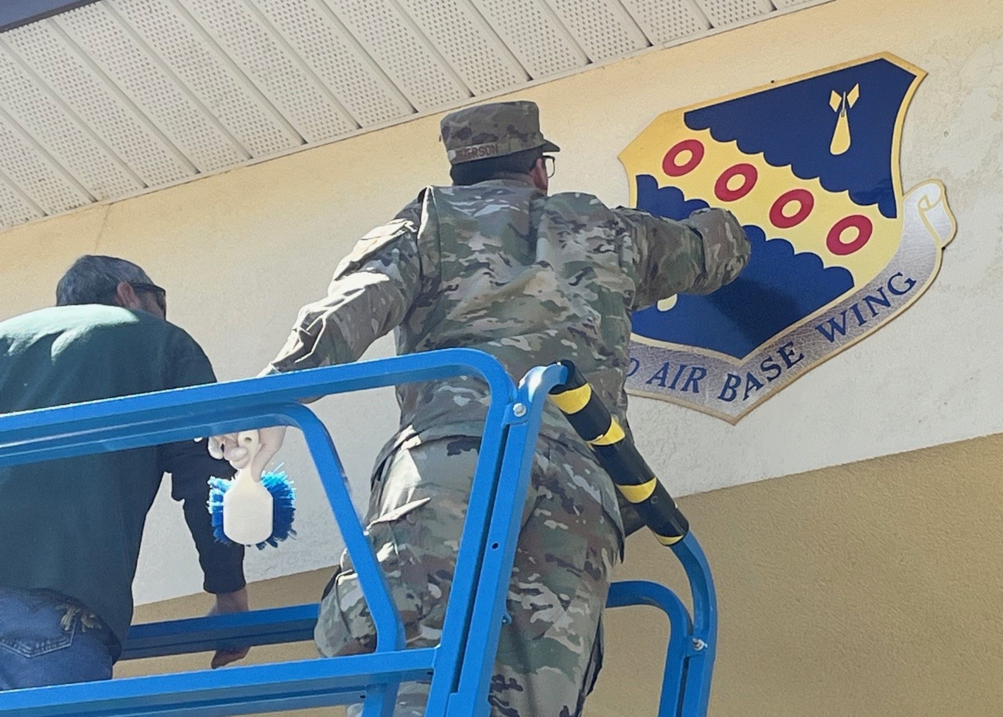 Airmen from the 42d Air Base Wing, Maxwell Air Force Base, Ala., clean and inspect the wing shield at the base’s front gate, 18 March 2026. The wing has initiated a comprehensive campaign to address long-standing challenges and reflect the installation as a standard of excellence. The ‘Installation Excellence Campaign Plan 2026’ outlines a coordinated effort tackle systemic historical issues with infrastructure, appearance and customer service. (U.S. Air Force photo)
