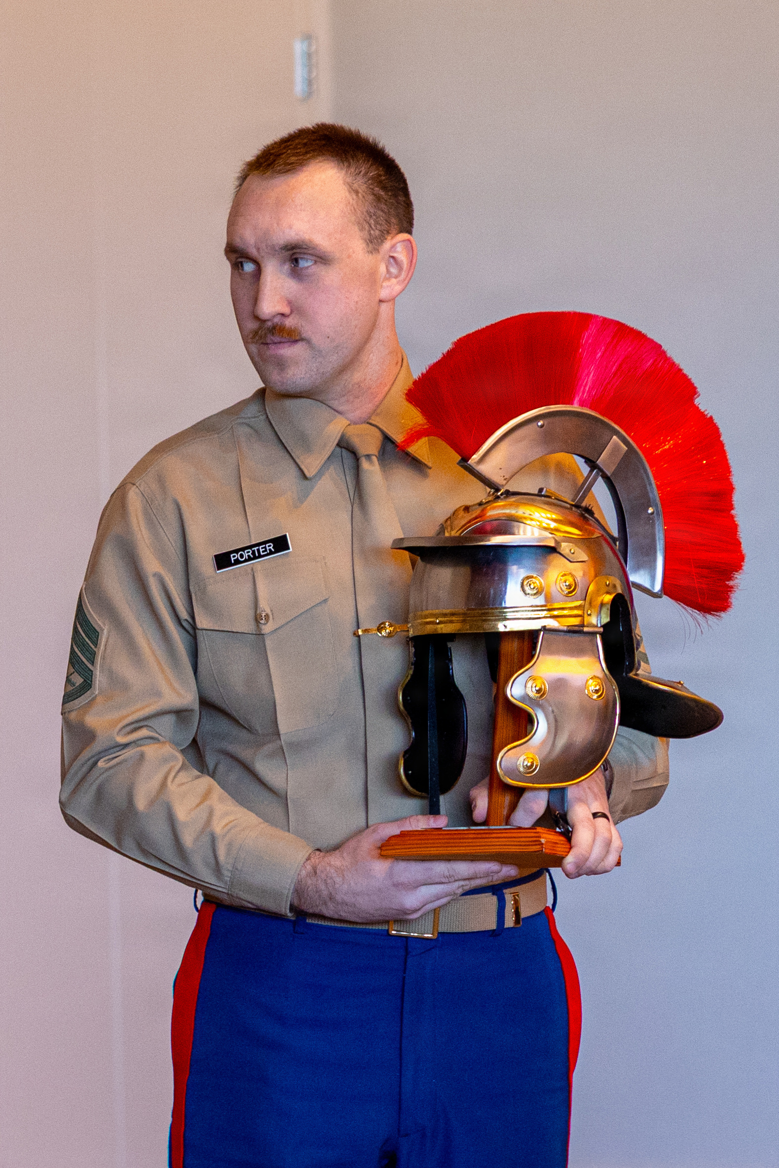 U.S. Marine Corps Staff Sgt. Alex Porter, a recruiter with Recruiting Station Kansas City, receives the Centurion Award in Kansas City, Missouri, Feb. 21, 2026. The title "Centurion" is awarded to Marines who write 100 or more contracts during their 36 months on recruiting duty. (U.S. Marine Corps photo by Lance Cpl. Kayla Goldman)