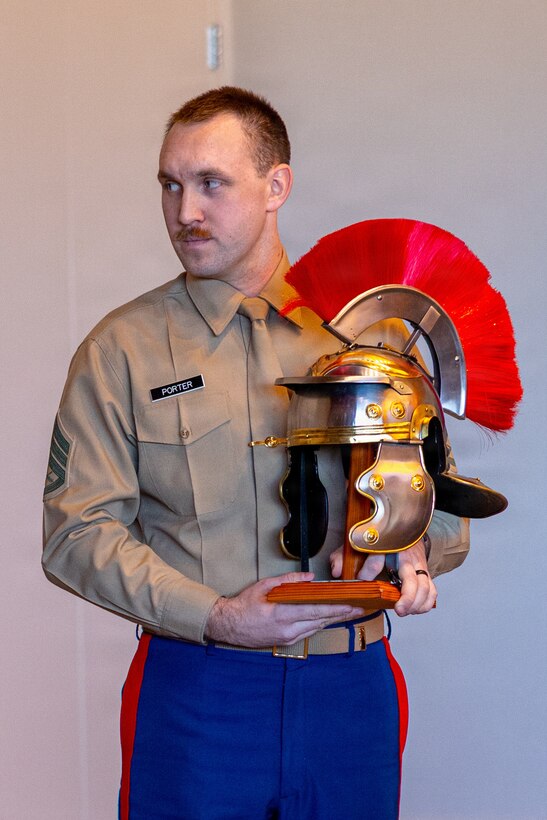 U.S. Marine Corps Staff Sgt. Alex Porter, a recruiter with Recruiting Station Kansas City, receives the Centurion Award in Kansas City, Missouri, Feb. 21, 2026. The title "Centurion" is awarded to Marines who write 100 or more contracts during their 36 months on recruiting duty. (U.S. Marine Corps photo by Lance Cpl. Kayla Goldman)