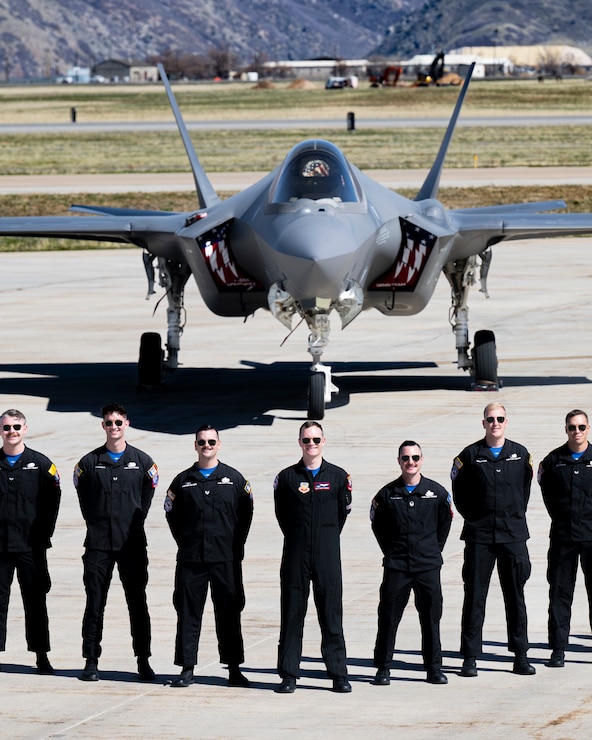 A photo of an F-35 crew chief standing in front of a jet