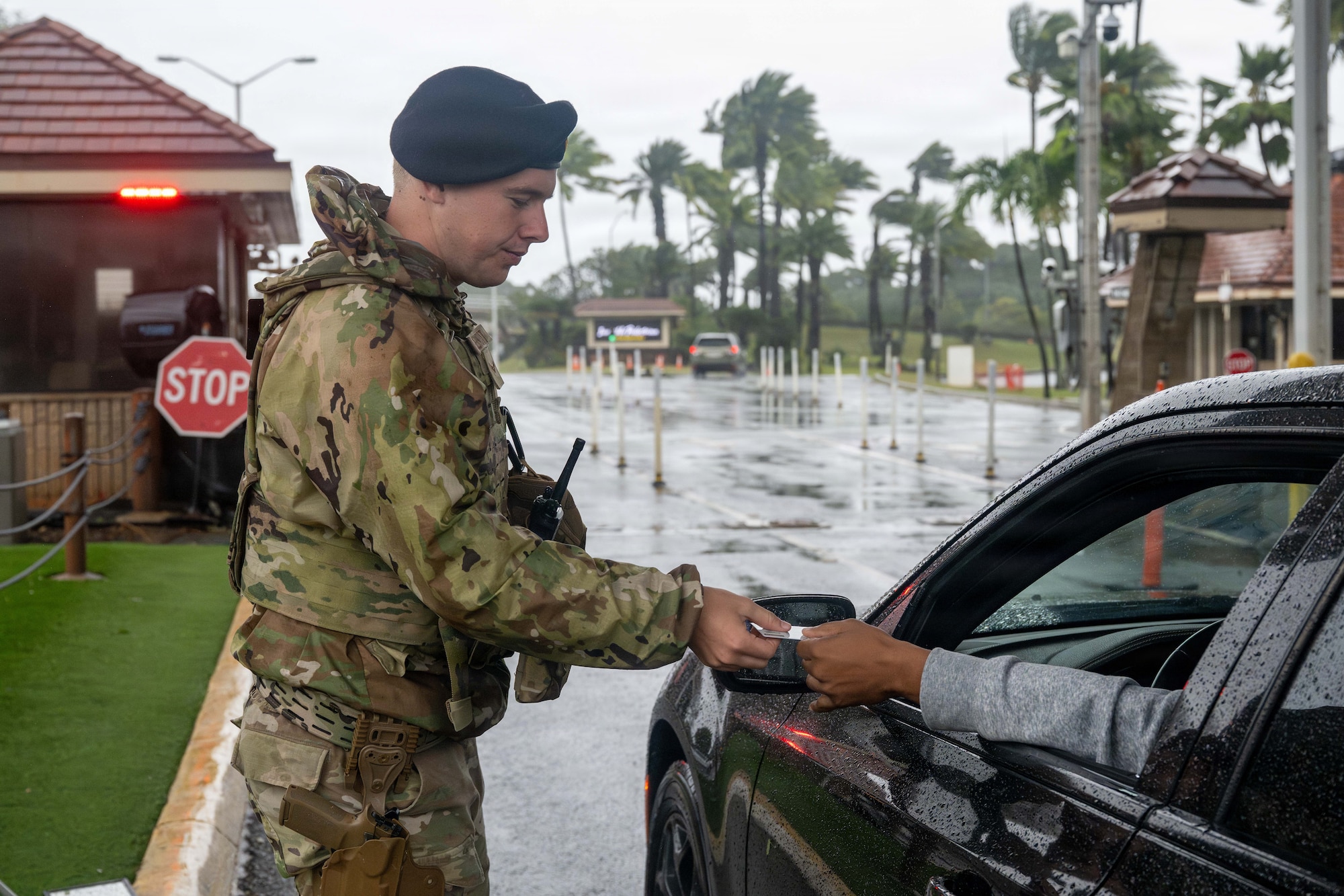 An airman hands back a driver's ID card.