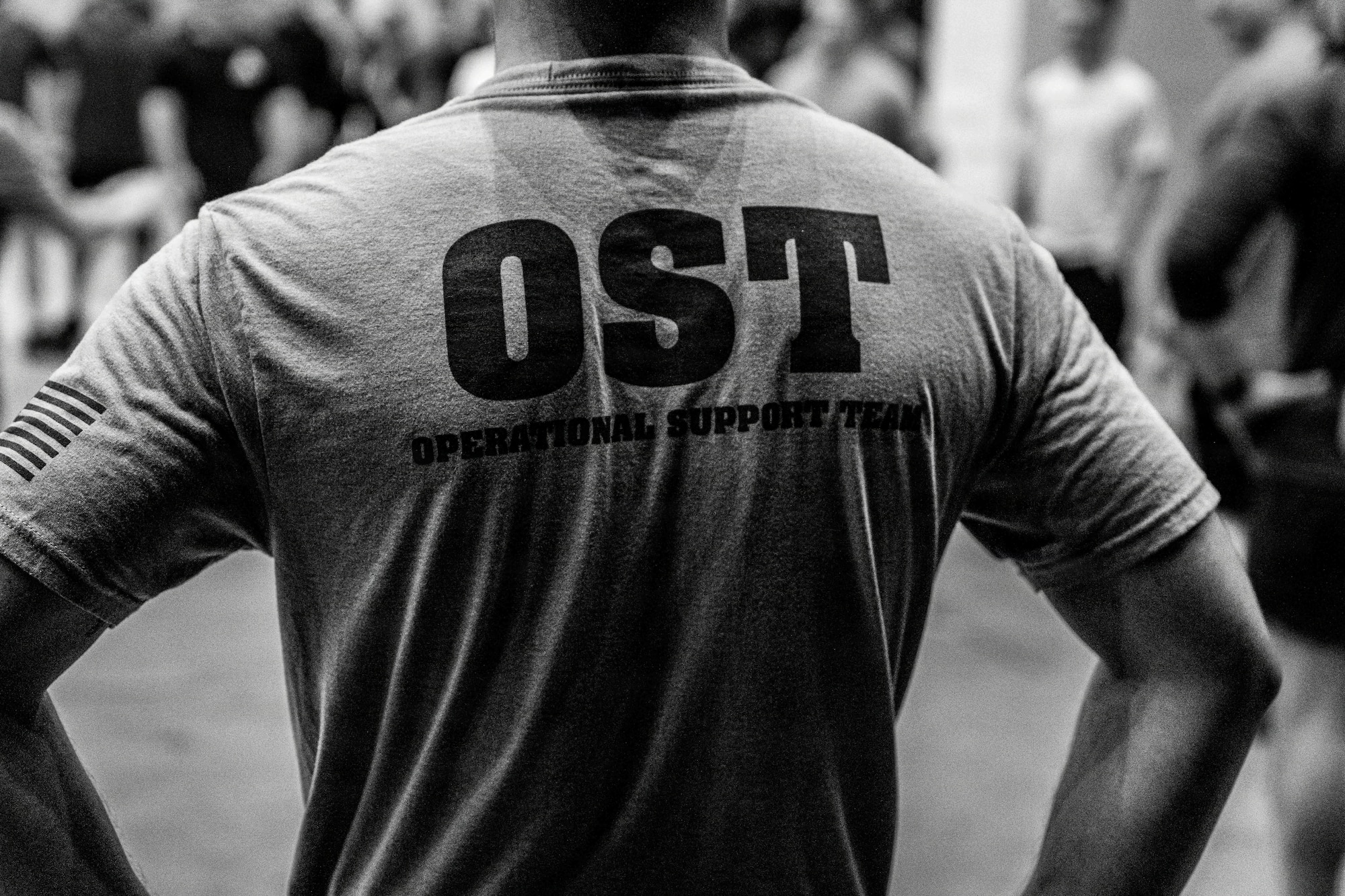 A close up photo of an Airman's shirt that spells OST, which stands for operational support team.