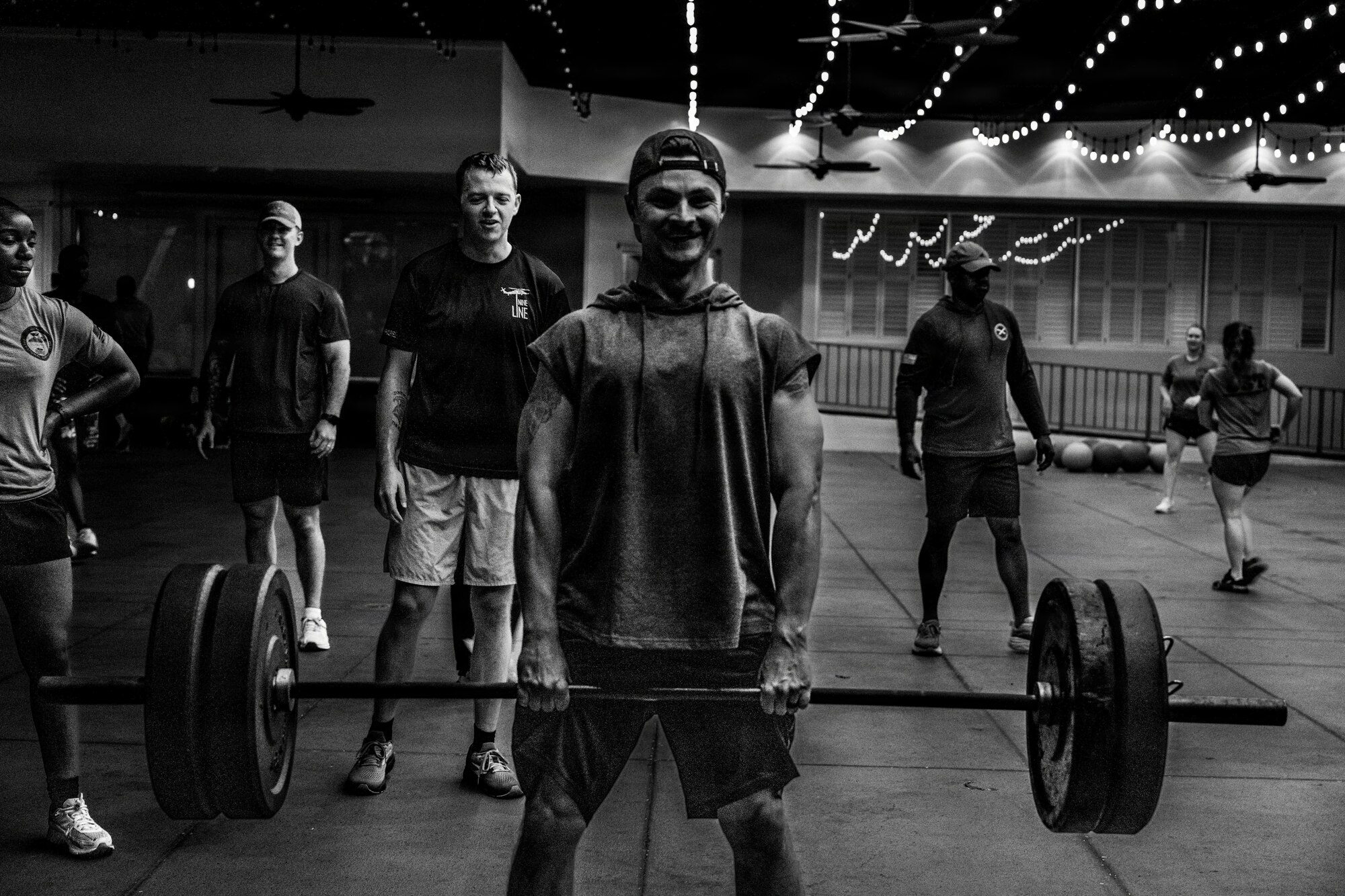 An Airman performs a deadlift with weights during a workout.