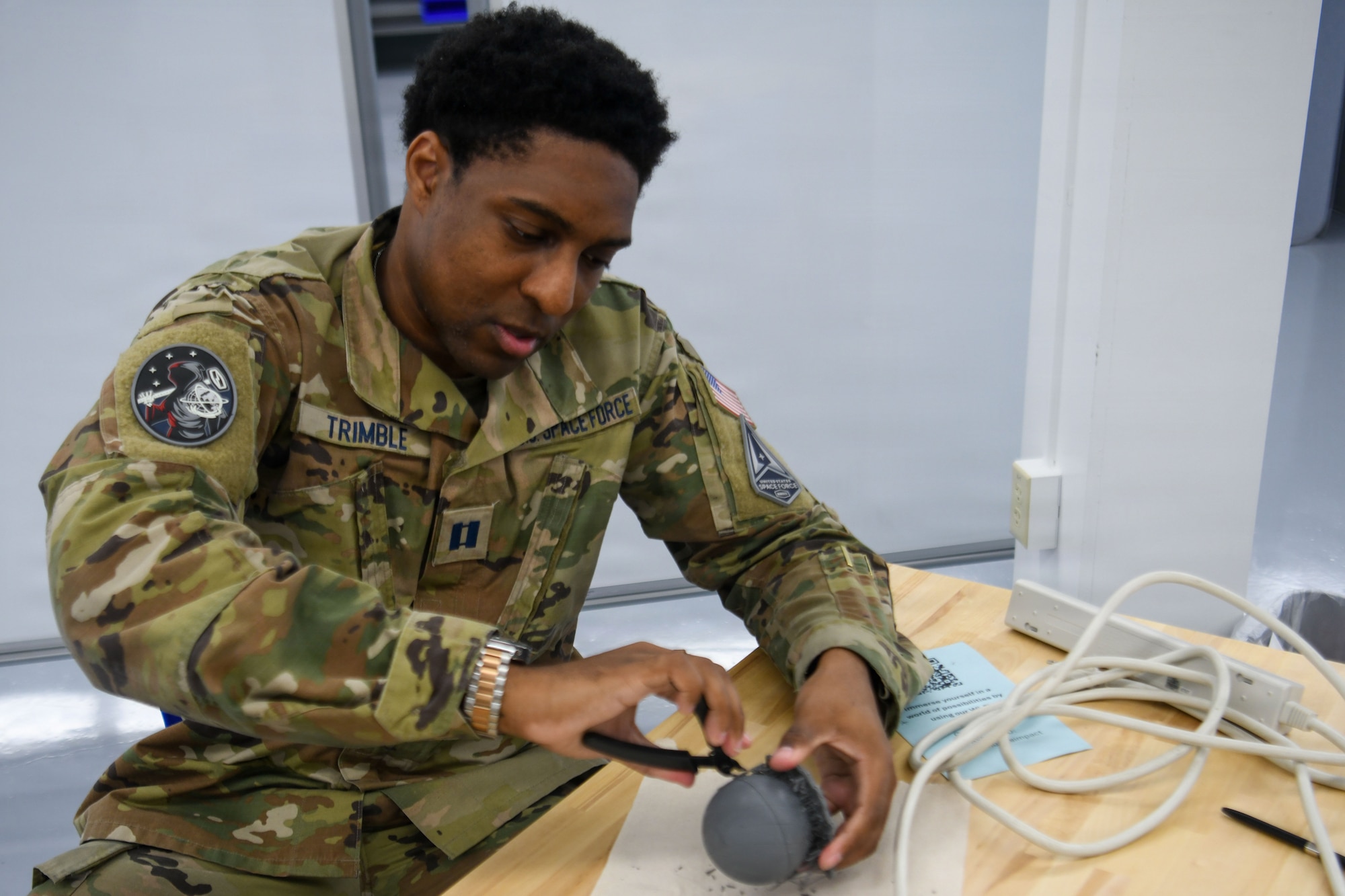 U.S. Space Force Capt. Jamiel Trimble II, Cyber Initial Mission Analysis Team acquisitions focus lead from Fort George G. Meade, holds a 3D printing model.