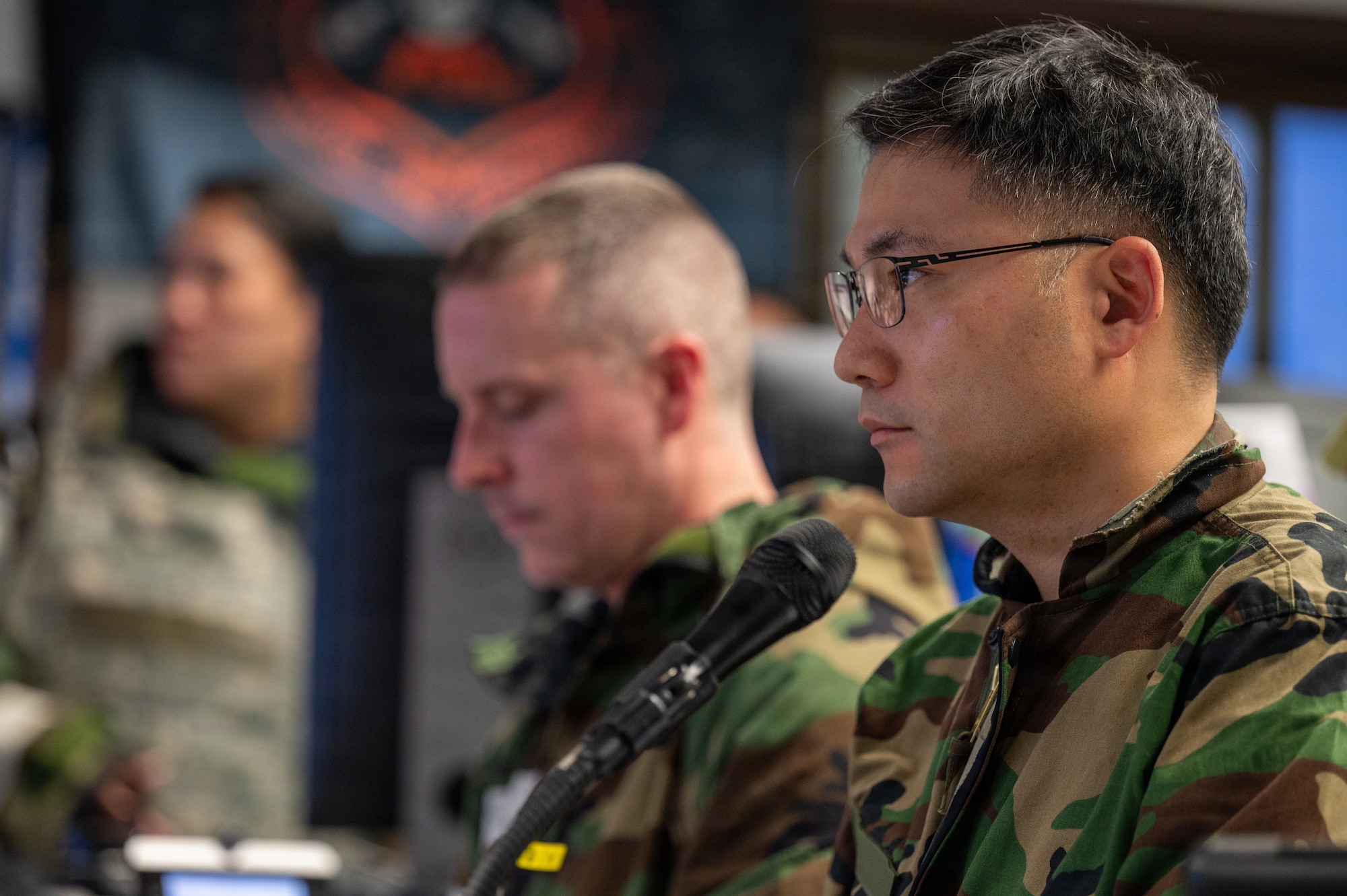 Republic of Korea air force Lt. Col. Cha Seungju, Combined Air Logistics Center chief of staff, listens to a shift change brief during exercise Freedom Shield 26 at Osan Air Base, Republic of Korea, March 12, 2026.