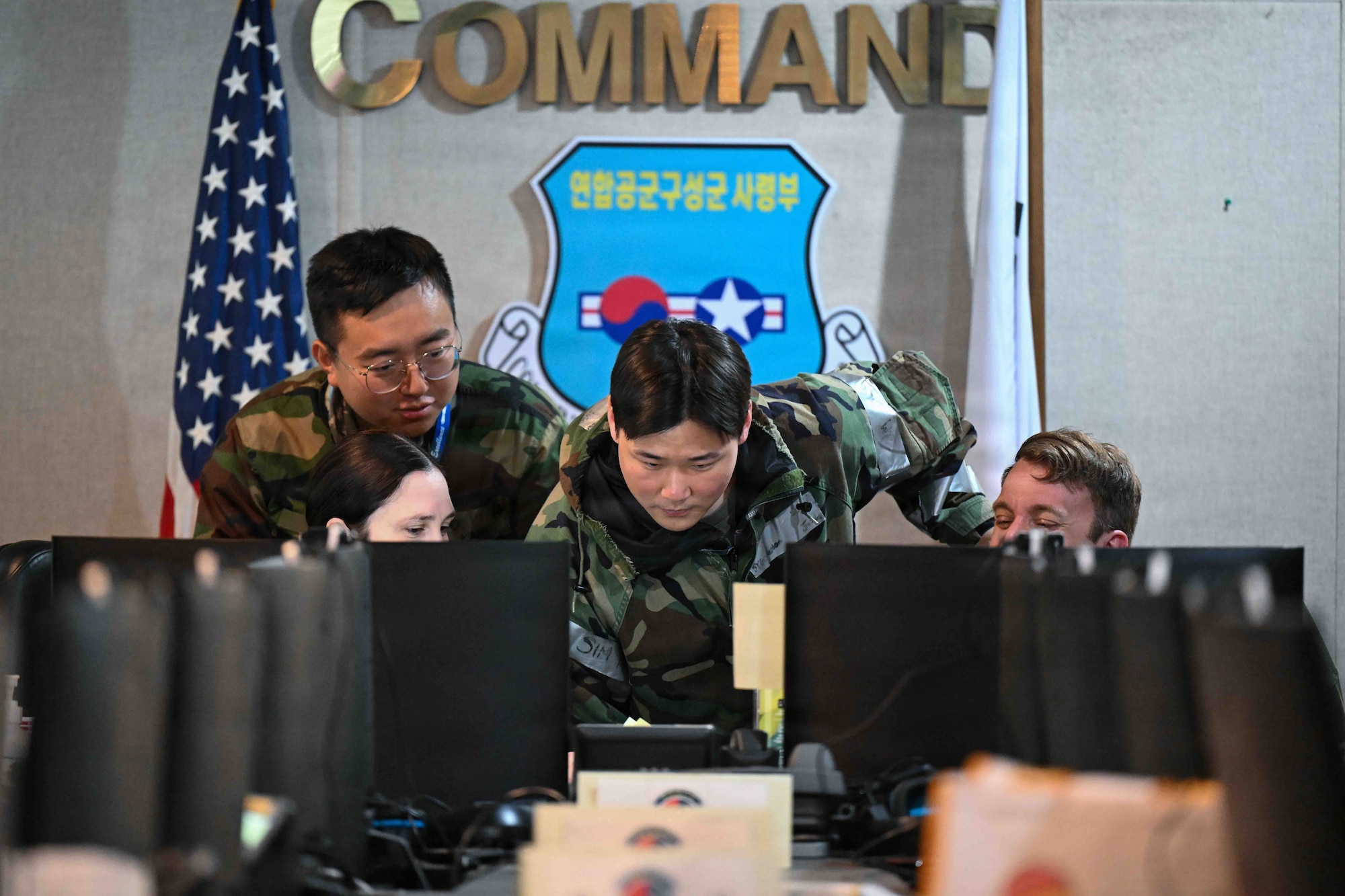 U.S. Air Force Staff Sgt. Byeongwoo Jung, center, Seventh Air Force joint plans translator, aids in translating during a mission briefing at the Combined Air Component Command as part of exercise Freedom Shield 26 at Osan Air Base, Republic of Korea, March 12, 2026.