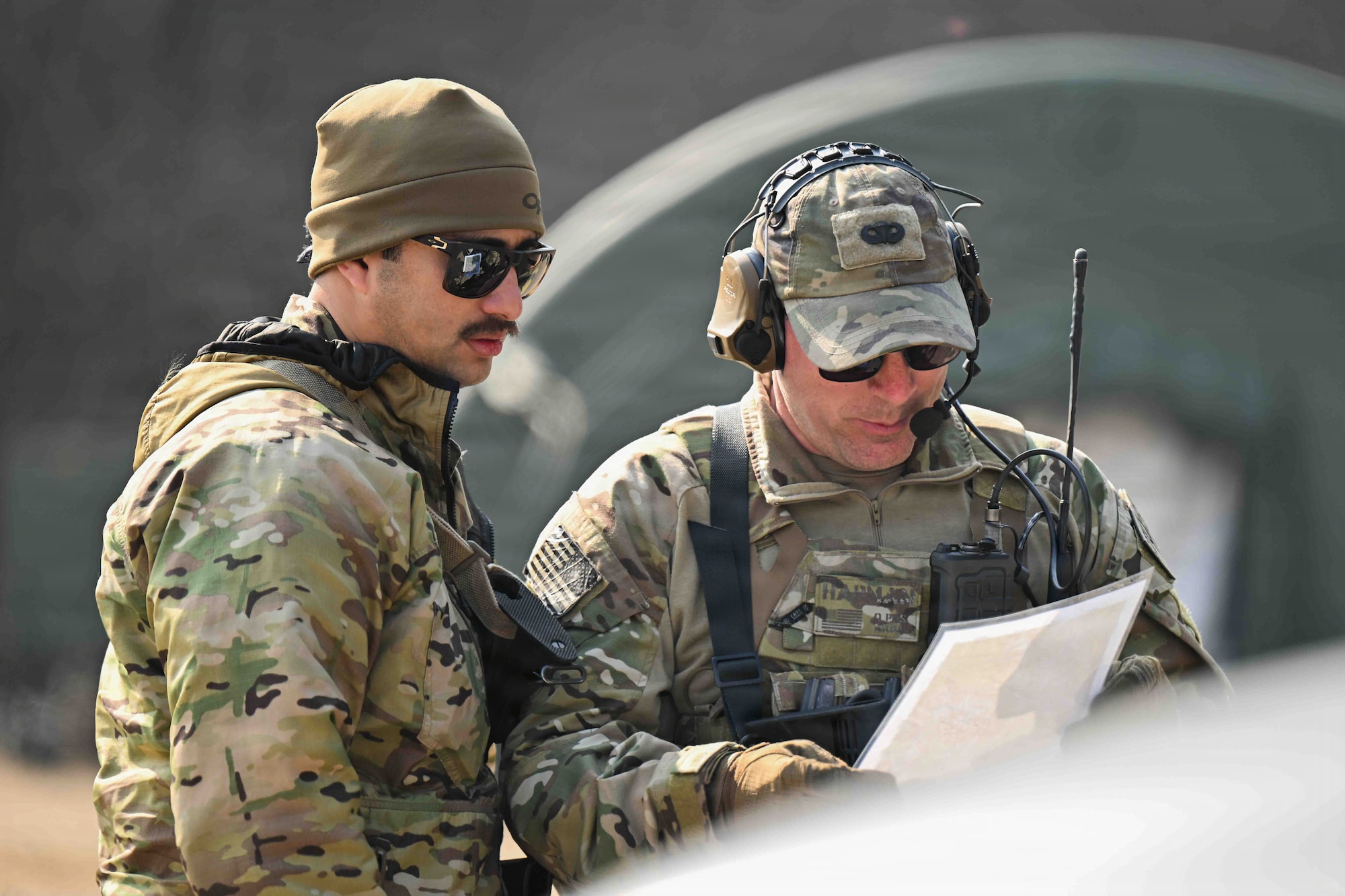 U.S. Air Force Staff Sgt. Alex Camez (left), and Master Sgt. William Harman (right), members of the 607th Air Support Operations Group, discuss training plans for Airmen at Rodriguez Live Fire Complex, Republic of Korea, March 17, 2026.
