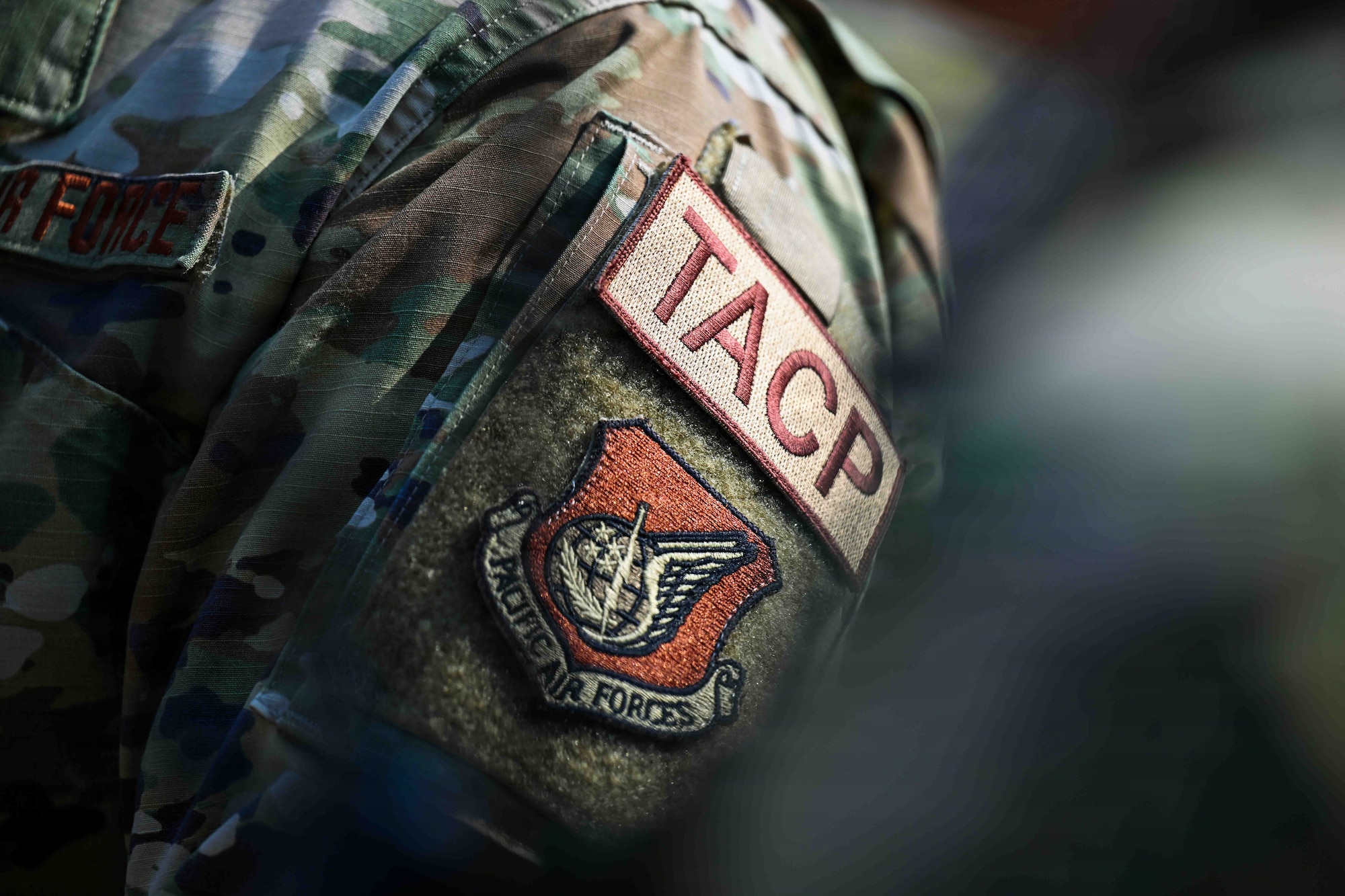 A U.S. Air Force Tactical Air Control Party Airman from the 607th Air Support Operations Group shows off his patch during combat readiness training at Rodriguez Live Fire Complex, Republic of Korea, March 17, 2026.