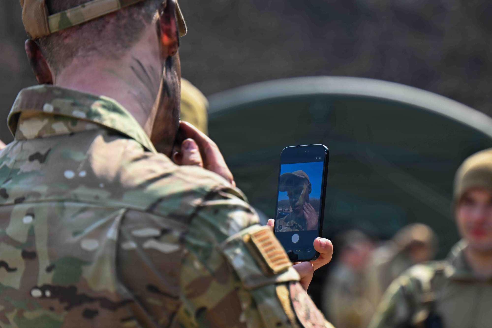 U.S. Air Force Senior Airman Joshua Guilliams, 51st Operations Support Squadron, applies facial camouflage during combat readiness training for exercise Freedom Shield 26 at Rodriguez Live Fire Complex, Republic of Korea, March 17, 2026.