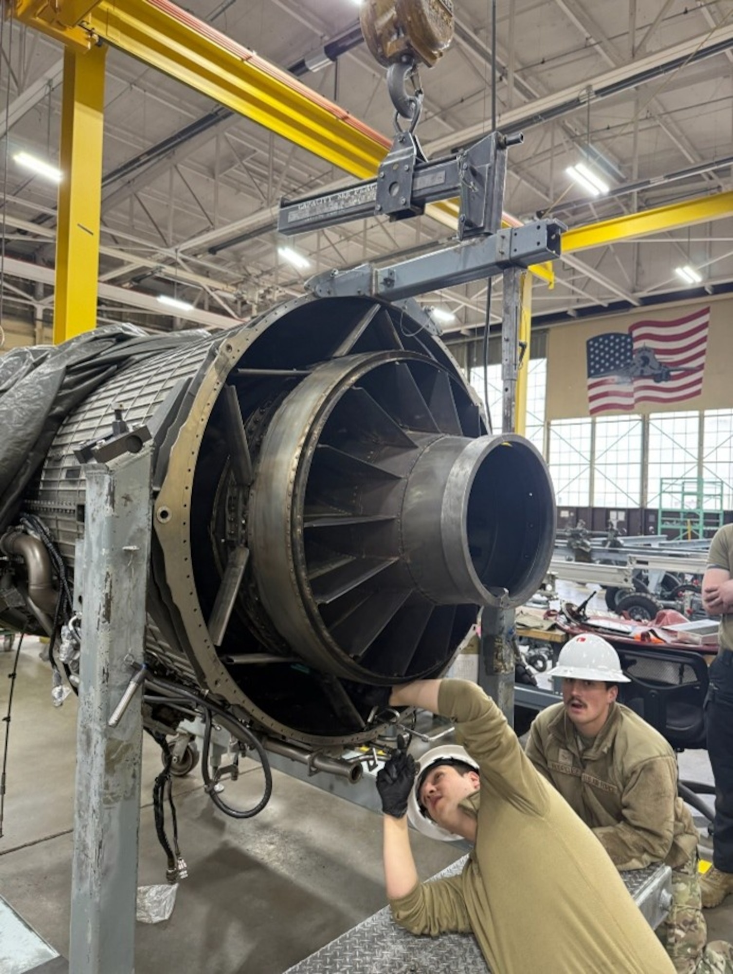 U.S. Air Force Staff Sgt. Anthony Martin and Airman 1st Class Fabian Rodriguez, 372nd Training Squadron B-1B Propulsion students, perform the removal of the F-101’s engine turbine frame.