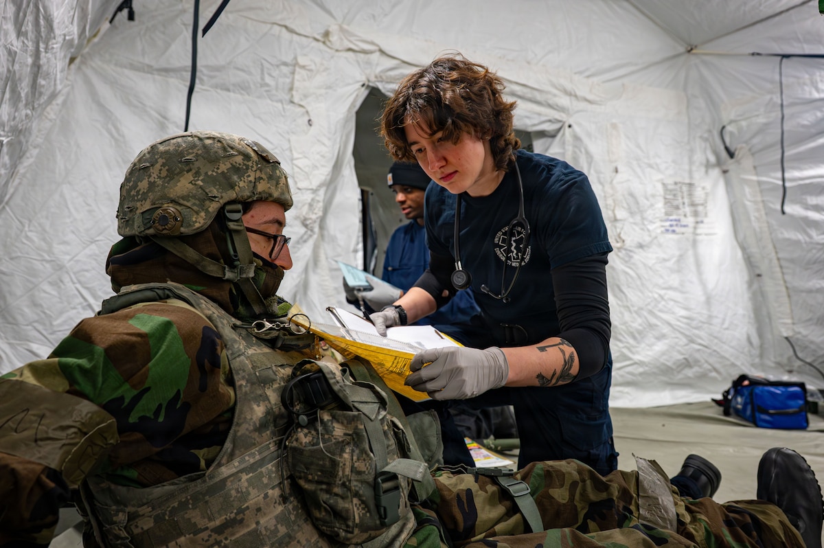 A paramedic assesses a patient.