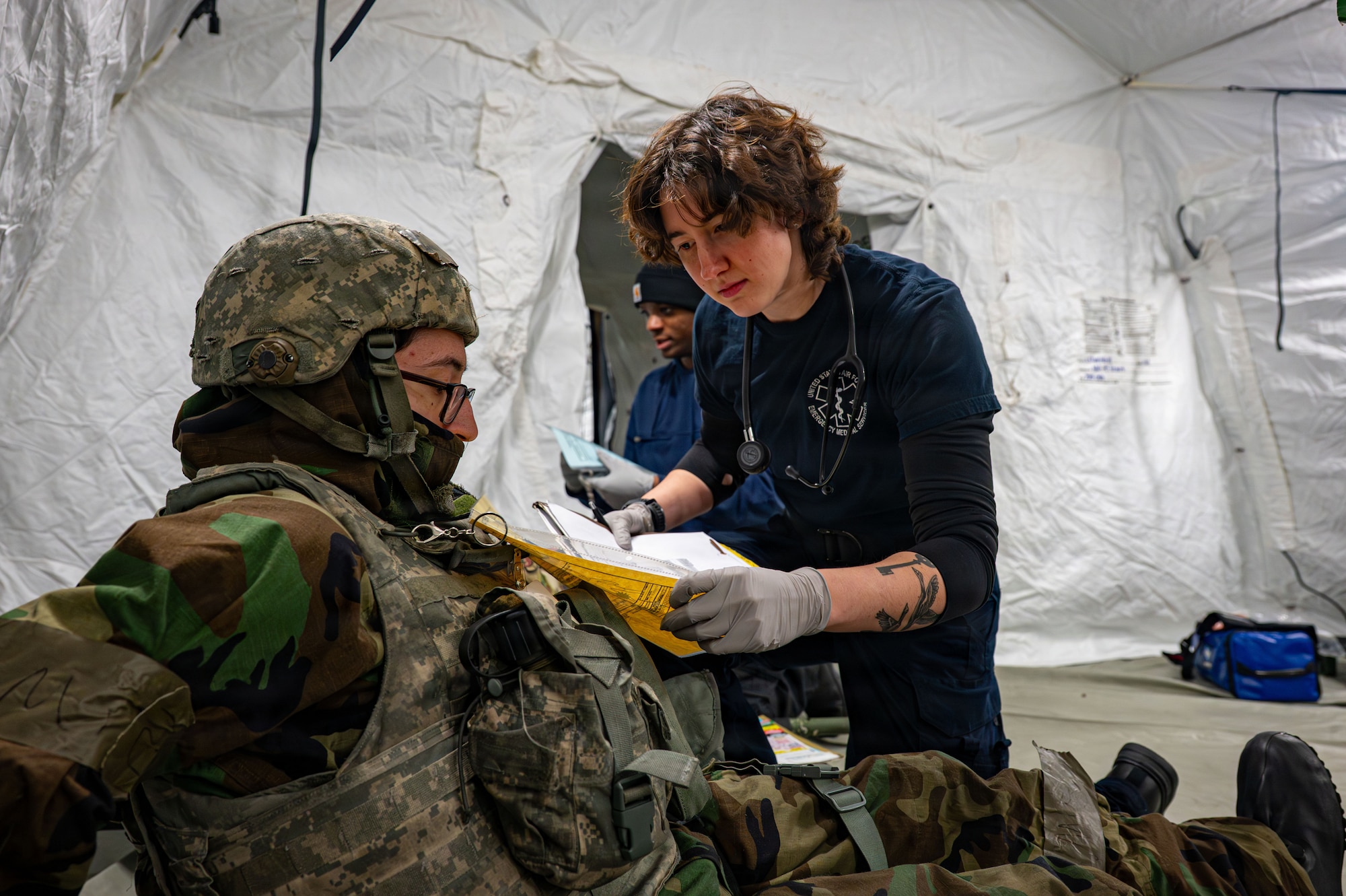 A paramedic assesses a patient.