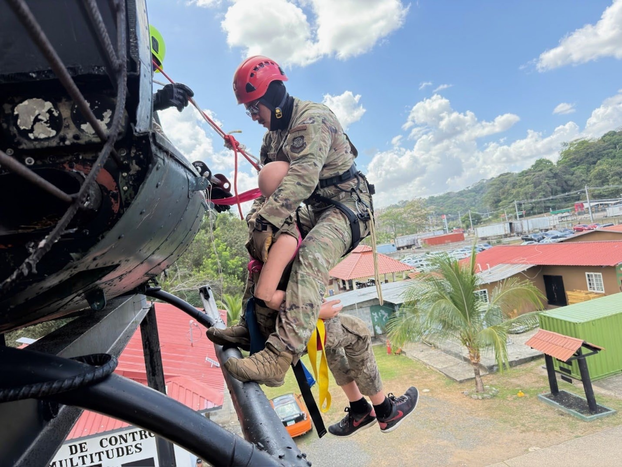 Man repels out of helicopter with a dummy.
