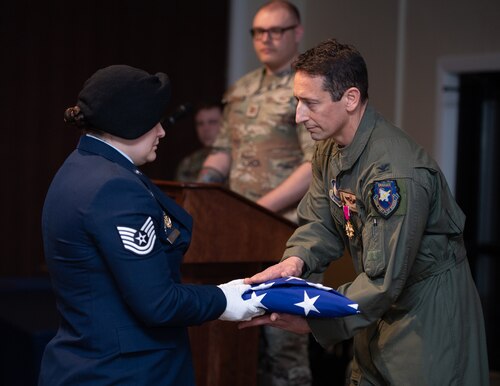 Image of a person receiving a folded flag.