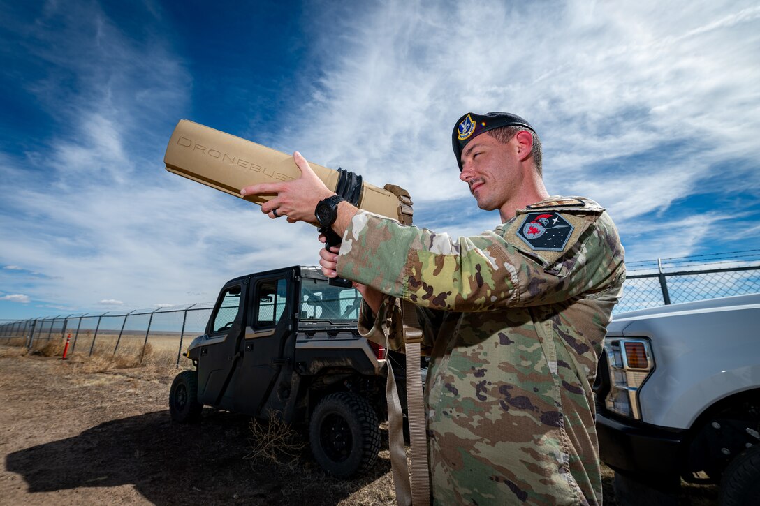 A Defender examines a drone buster.