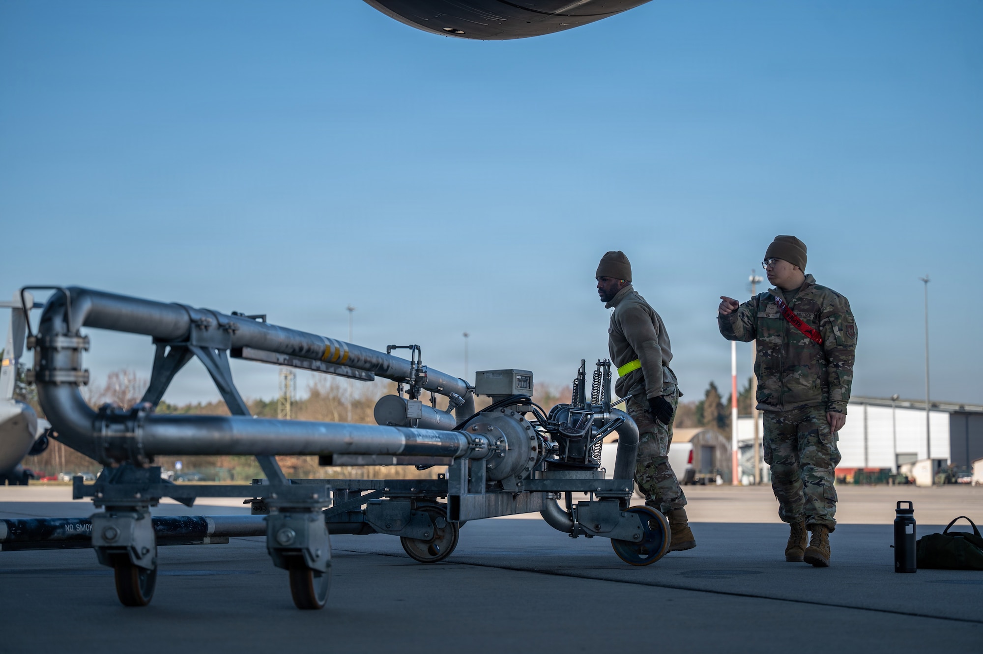 Airman 1st Class Gavan Ko, right, and Senior Airman Tyis Boykin, 6th Logistics Readiness Squadron fuels distributors, work together to fuel a C-5M Super Galaxy at Ramstein Air Base, Germany, March 4, 2026.