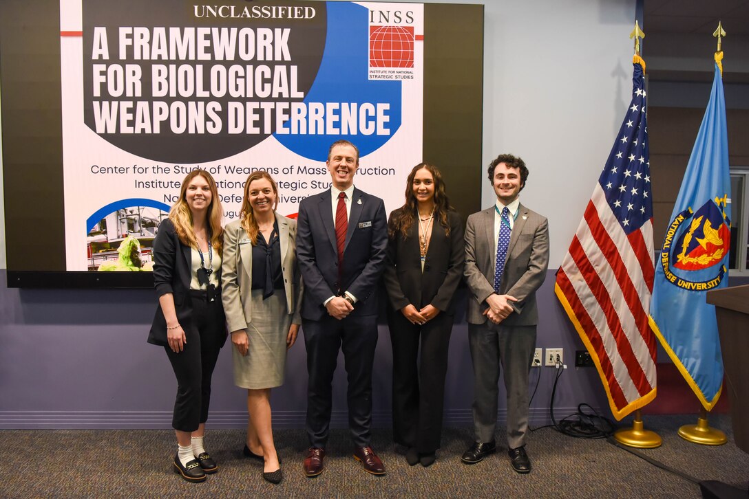INSS Center for Strategic Deterrence and WMD Studies employees stand in front of the Framework for Biological Weapons Deterrence: Report Rollout event at National Defense University.