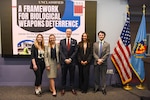 INSS Center for Strategic Deterrence and WMD Studies employees stand in front of the Framework for Biological Weapons Deterrence: Report Rollout event at National Defense University.