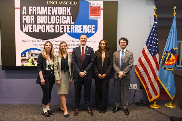 INSS Center for Strategic Deterrence and WMD Studies employees stand in front of the Framework for Biological Weapons Deterrence: Report Rollout event at National Defense University.