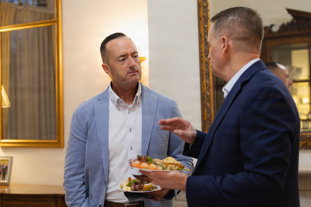 U.S. Marine Corps Sgt. Maj. Christopher J. Adams, left, command senior enlisted leader of III Marine Expeditionary Force, and U.S. Marine Corps Maj. Gen. Douglas K. Clark, deputy commander, Marine Forces Reserve and Marine Forces South, discuss various topics at a social event during the Sergeant Major of the Marine Corps Force Level Summit at Quarters A, New Orleans, March 9, 2026. The summit was held for senior officers and senior enlisted advisors, serving at the Marine Forces level, to discuss important and emerging topics in the Marine Corps. (U.S. Marine Corps photo by Cpl. Van Hoang)