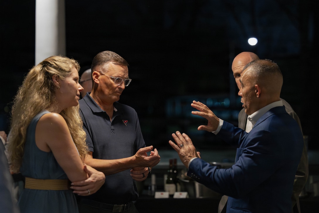 U.S. Marine Corps Lt. Gen. Leonard F. Anderson IV, second from left, commander, Marine Forces Reserve and Marine Forces South, speaks with Sgt. Maj. Edwin A. Mota, right, command senior enlisted leader of Marine Forces Reserve and Marine Forces South, at a social event during the Sergeant Major of the Marine Corps Force Level Summit at Quarters A, New Orleans, March 9, 2026. The summit was held for senior officers and senior enlisted advisors, serving at the Marine Forces level, to discuss important and emerging topics in the Marine Corps. (U.S. Marine Corps photo by Cpl. Van Hoang)