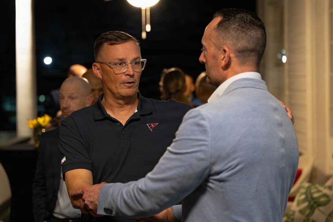 U.S. Marine Corps Lt. Gen. Leonard F. Anderson IV, left, commander, Marine Forces Reserve and Marine Forces South, bids farewell to Sgt. Maj. Christopher J. Adams, command senior enlisted leader of III Marine Expeditionary Force, at a social event during the Sergeant Major of the Marine Corps Force Level Summit at Quarters A, New Orleans, March 9, 2026. The summit was held for senior officers and senior enlisted advisors, serving at the Marine Forces level, to discuss important and emerging topics in the Marine Corps. (U.S. Marine Corps photo by Cpl. Van Hoang)