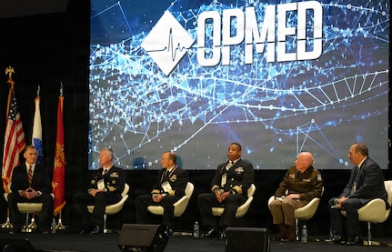 SAN ANTONIO – (March 17, 2026) – Dr. Michael McGinnis (left), executive director of the U.S. Navy Bureau of Medicine and Surgery, and director of the Navy Medicine Civilian Corps, served as the moderator for a continuing education panel titled, “Overcoming the Unique Medical Challenges across the Indo-Pacific Theater during the 2026 Annual Operational Medicine Symposium (OpMed) & Technology Showcase held at the Henry B. Gonzales Convention Center.  Panelists included Capt. Niels Olson, Medical Corps, chief medical officer, Human Systems Portfolio, Defense Innovation Unit; Capt. Delbert Clark, Medical Corps, command surgeon, 3rd Marine Division; Capt. Richard Gilliard Jr., Medical Service Corps, commanding officer, U.S. Naval Hospital Okinawa, Japan; U.S. Army Maj. Gen. Darrin Cox, commanding general, 18th Theater Medical Command; and Dr. Darrin Frye, chief science director, Naval Medical Research Unit San Antonio. OpMed is one of the largest and most influential military medical events in North America for senior medical officials, clinicians, government leaders, and solution providers. The symposium explores how the Military Health System is preparing for large scale combat operations by championing innovations in combat casualty care to strengthen warfighter survivability and enhance the medical readiness of the joint force. Navy Medicine is committed to expanding partnerships in the medical field and the importance of sharing best practices, advancing medical capabilities, research and training opportunities. (U.S. Navy photo by Burrell Parmer, NAMRU San Antonio Public Affairs/Released)