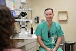 Maj. Brandon F. Harris, chief ophthalmologist at Carl R. Darnall Army Medical Center, speaks with a patient during an appointment in the ophthalmology clinic. Providers emphasize communication and personal connection to help patients feel heard and understood.
