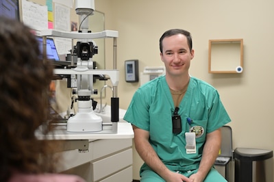 Maj. Brandon F. Harris, chief ophthalmologist at Carl R. Darnall Army Medical Center, speaks with a patient during an appointment in the ophthalmology clinic. Providers emphasize communication and personal connection to help patients feel heard and understood.