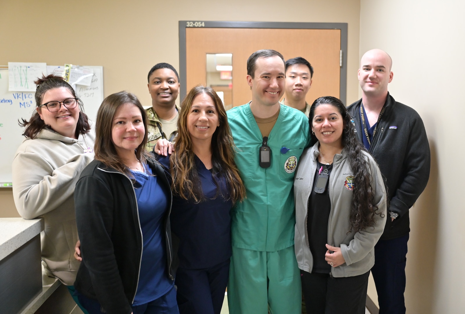 Maj. Brandon F. Harris, chief ophthalmologist, center, poses with members of the ophthalmology team at Carl R. Darnall Army Medical Center. The team includes technicians and clinical staff who support patient care for Soldiers, family members, and retirees.