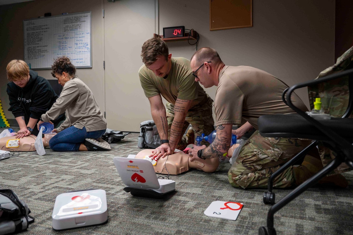Airmen and civilian employees participate in a basic life support class.