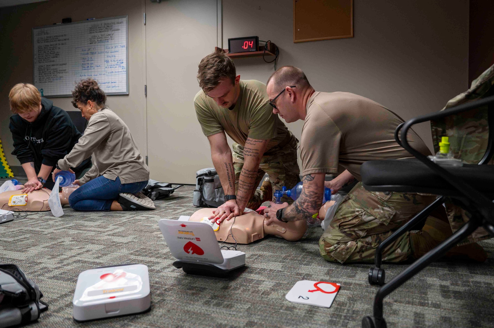 Airmen and civilian employees participate in a basic life support class.