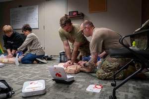 Airmen and civilian employees participate in a basic life support class.
